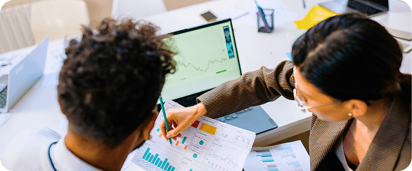 Analysts reviewing equity research data and charts to support a buy/sell recommendation