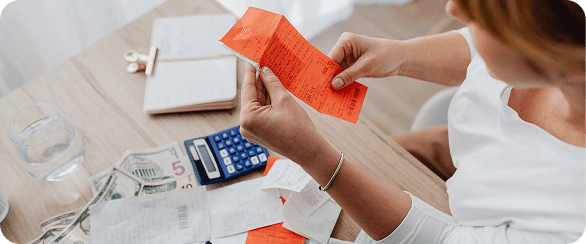 Operations professional reviewing procurement receipts and costs, supported by AI agents to identify savings