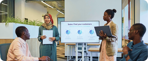 Sales team discussing market intelligence and competitor signals during a deal strategy session