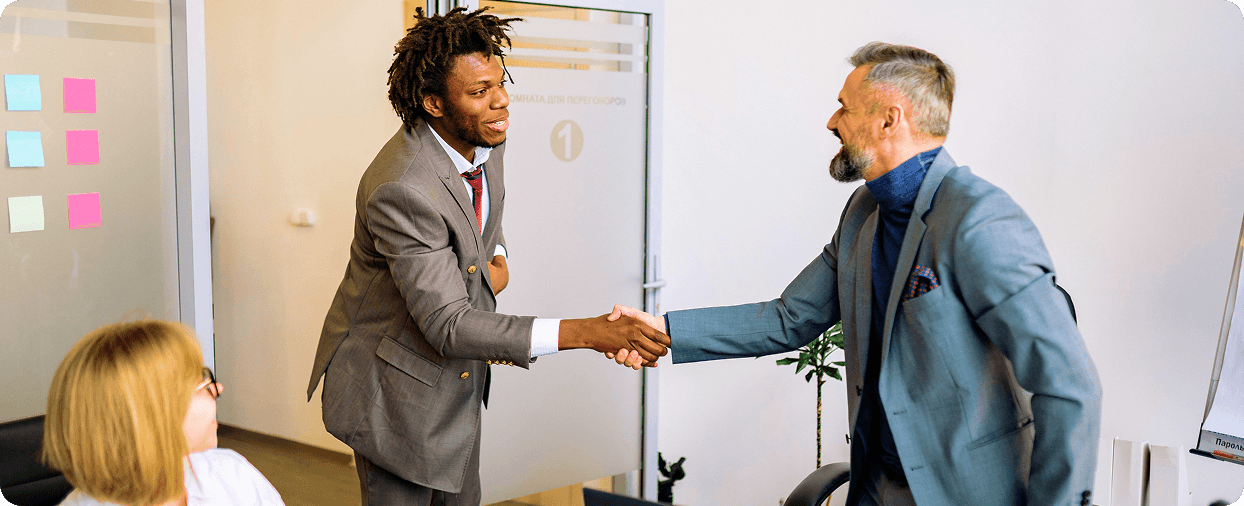 Sales professionals shaking hands after a meeting, supported by NSOffice.AI's governed enterprise AI platform