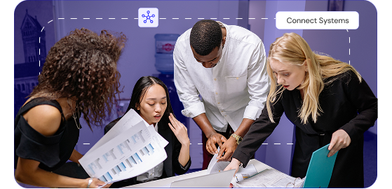 Team collaborating over documents with Connect Systems overlay — context layer across CRM, ERP, and HCM